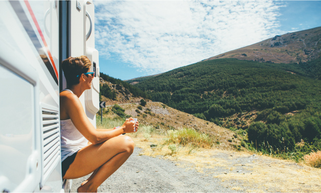 Girl in RV looking at mountains