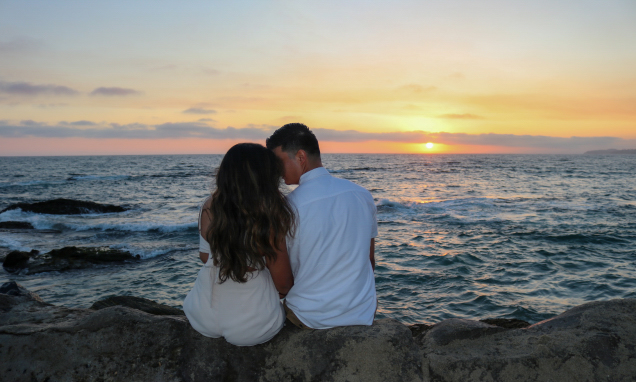 Couple on the beach watching the sun set