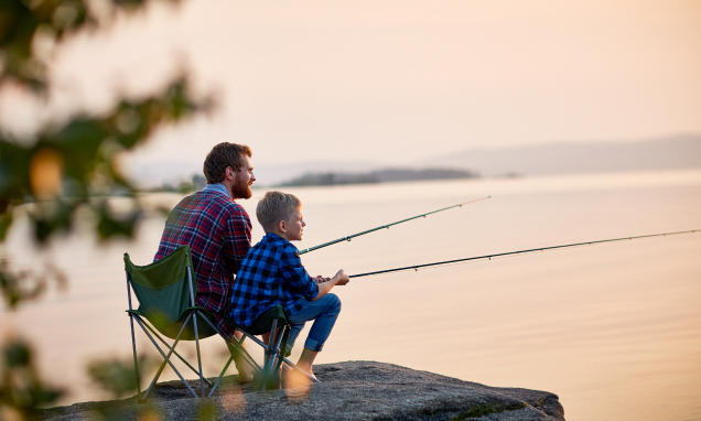 Father and son fishing on a lake