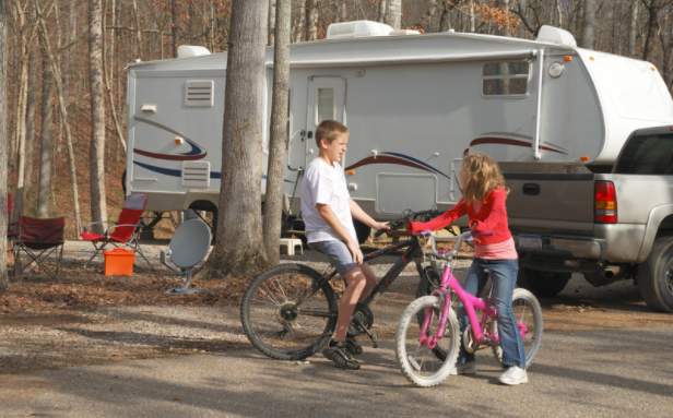 Kids riding bikes in a campground