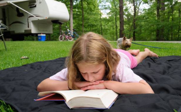 Girl reading in a campground