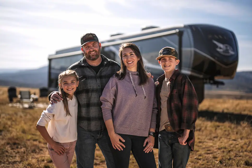 A family standing in front of an RV, with a testimonial from commending RVezy for seamless business operations and excellent customer support.