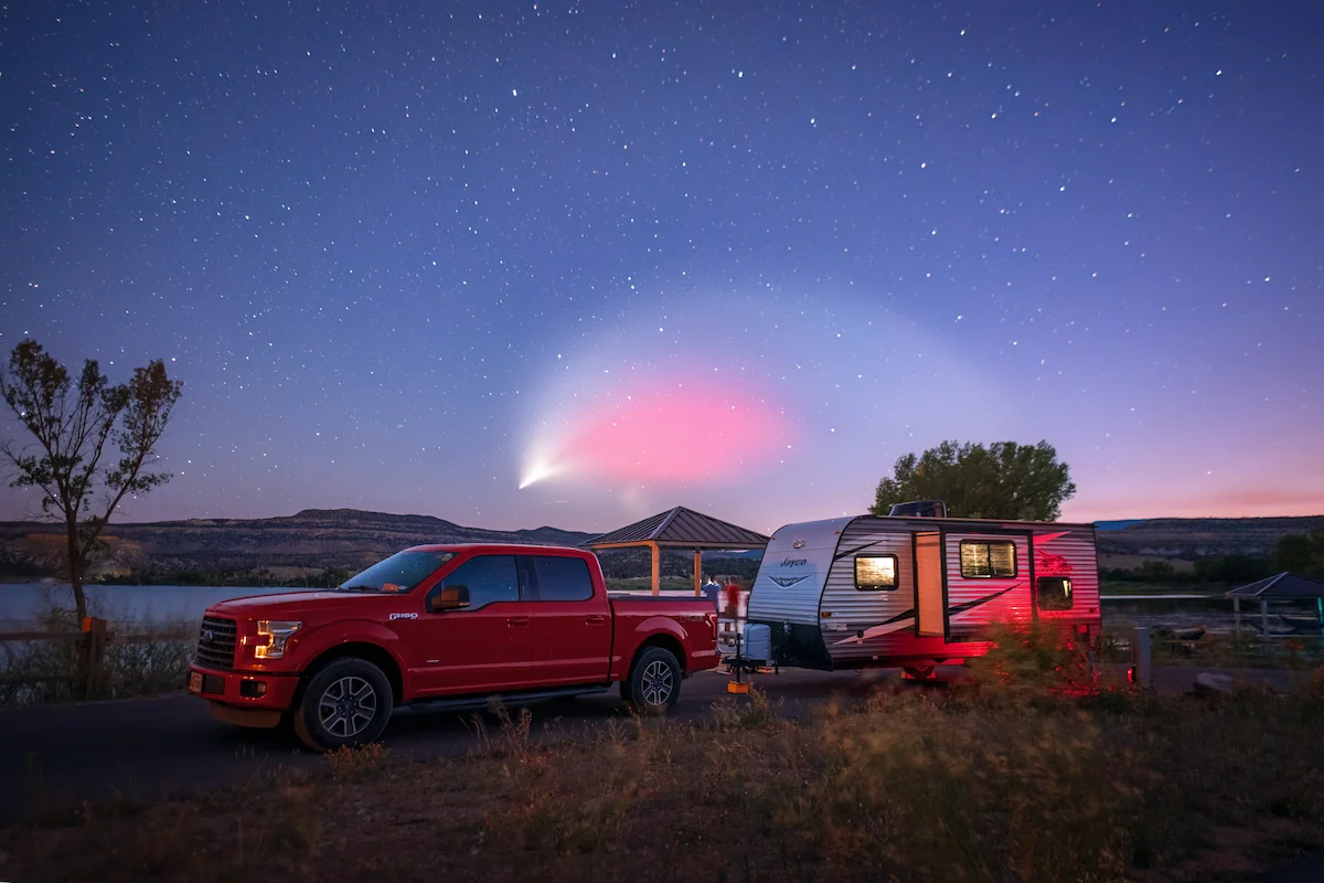 Shooting star over a camped towable RV
